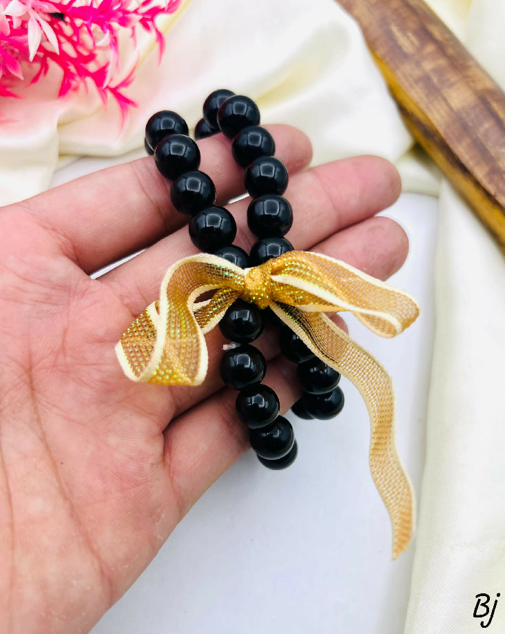 Elegant Black Bead Watch with Gold Accents